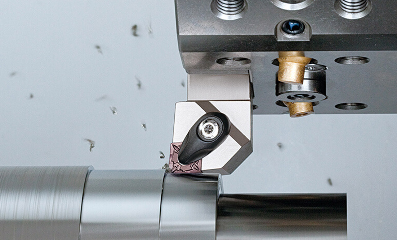 Close-up of a carbide insert machining metal during a turning process