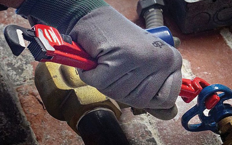 Worker using the right REED pipe wrench for the job