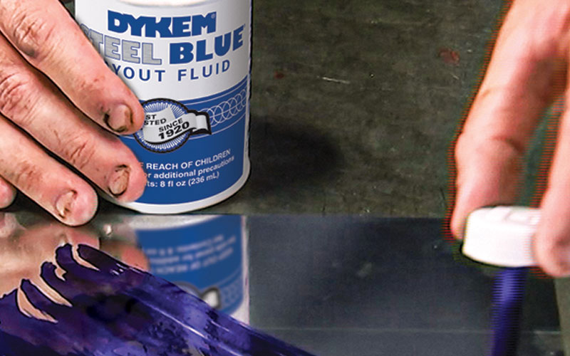 Dykem Steel Blue layout fluid used to mark a part for machining