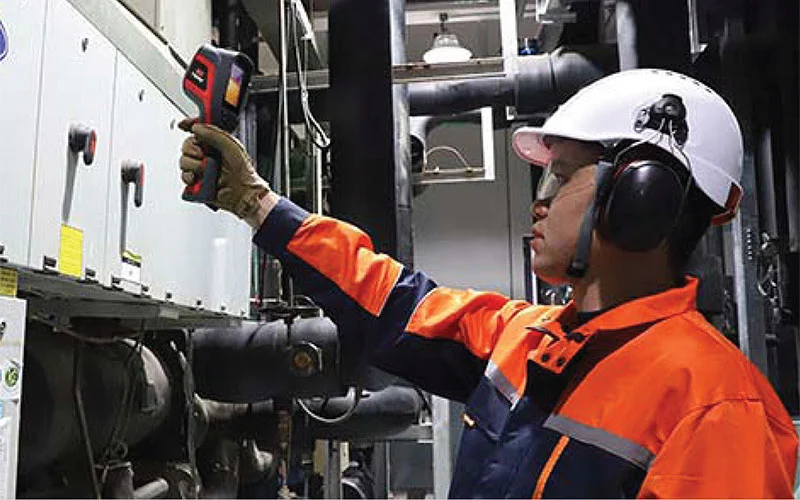 Maintenance worker using an IR camera for preventative maintenance